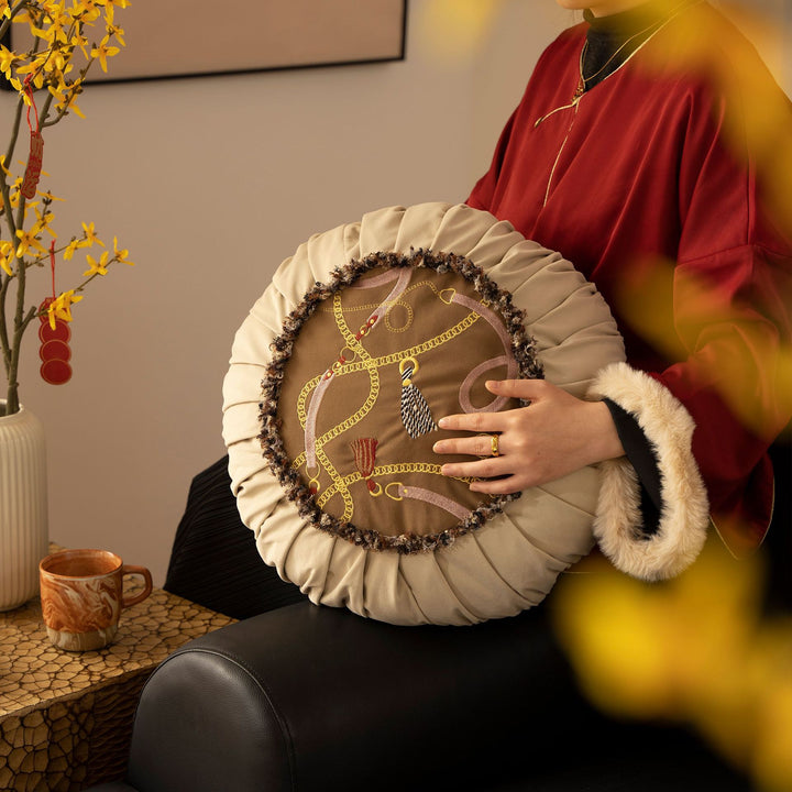 Round decorative cushion with pleated hem and embroidered central panel