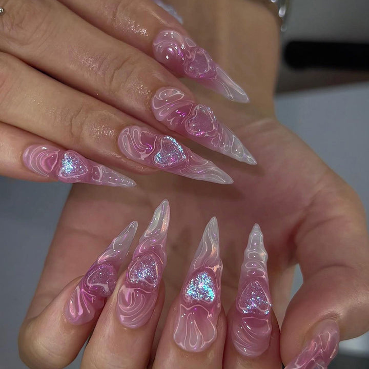 Artistic stiletto nails with heart design and glitter accents Bowlift