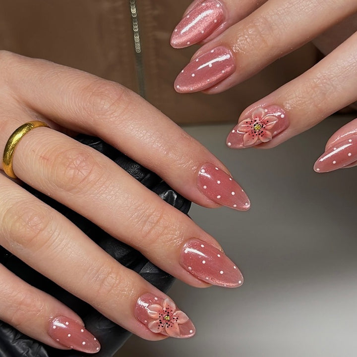 Artificial nail set with glamorous glitter design and floral accent Bowlift