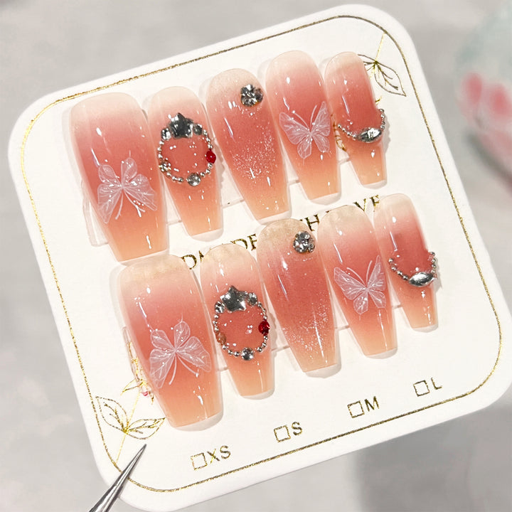 Artificial nail extensions with floral design and sparkling accents Bowlift