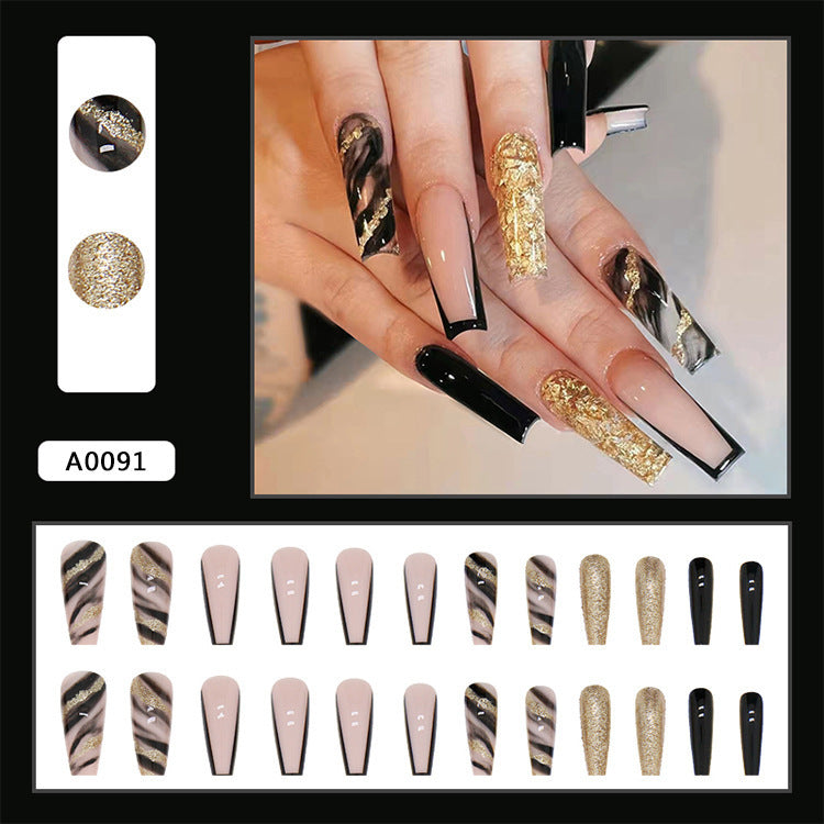 Acrylic nail set with luxurious golden accents and elegant designs Bowlift