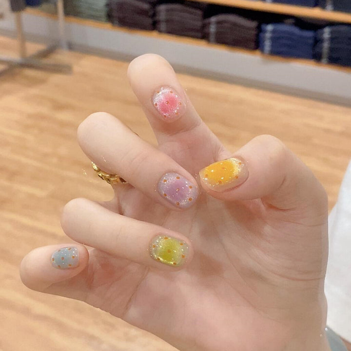 Glittering artificial nail tips in cheerful design Bowlift