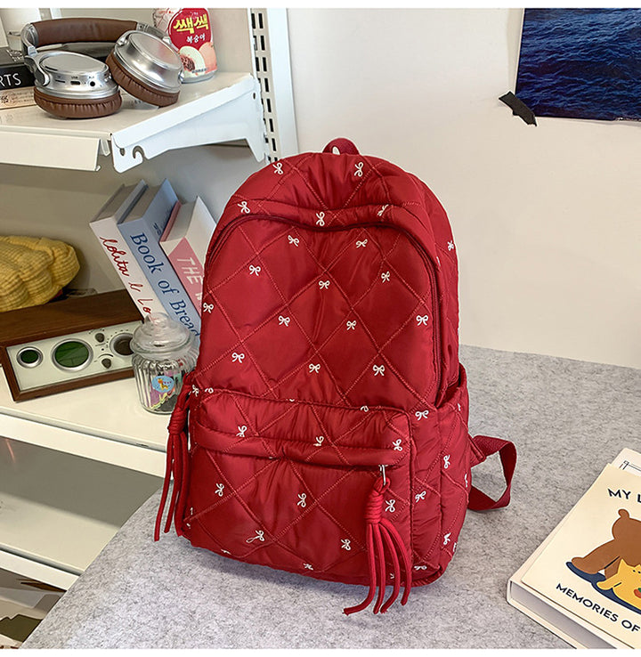 Quilted Backpack with Decorative Tassels