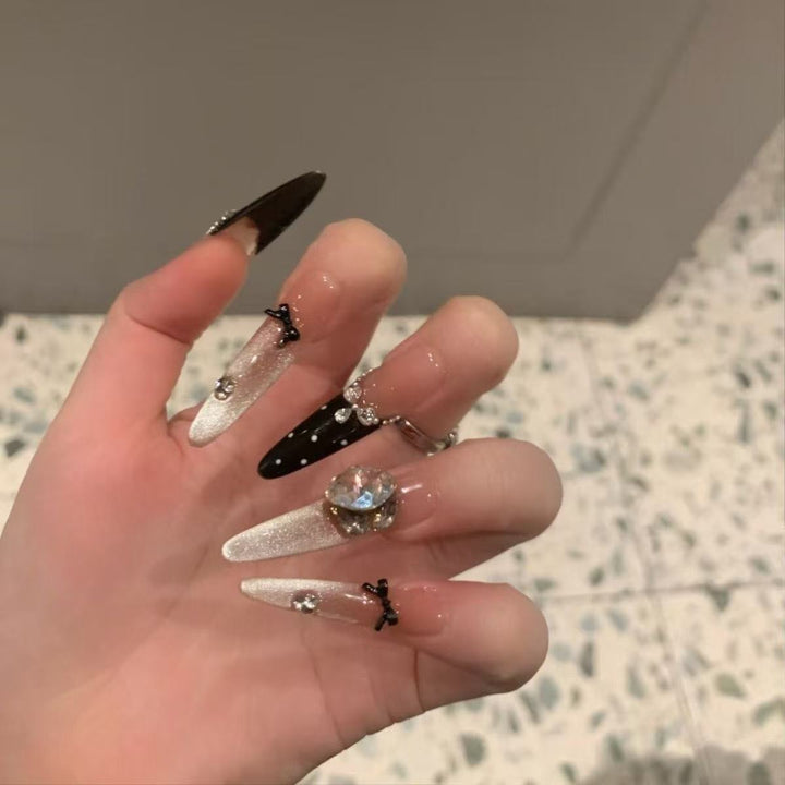 Artificial nails with luxurious crystal and bow accent