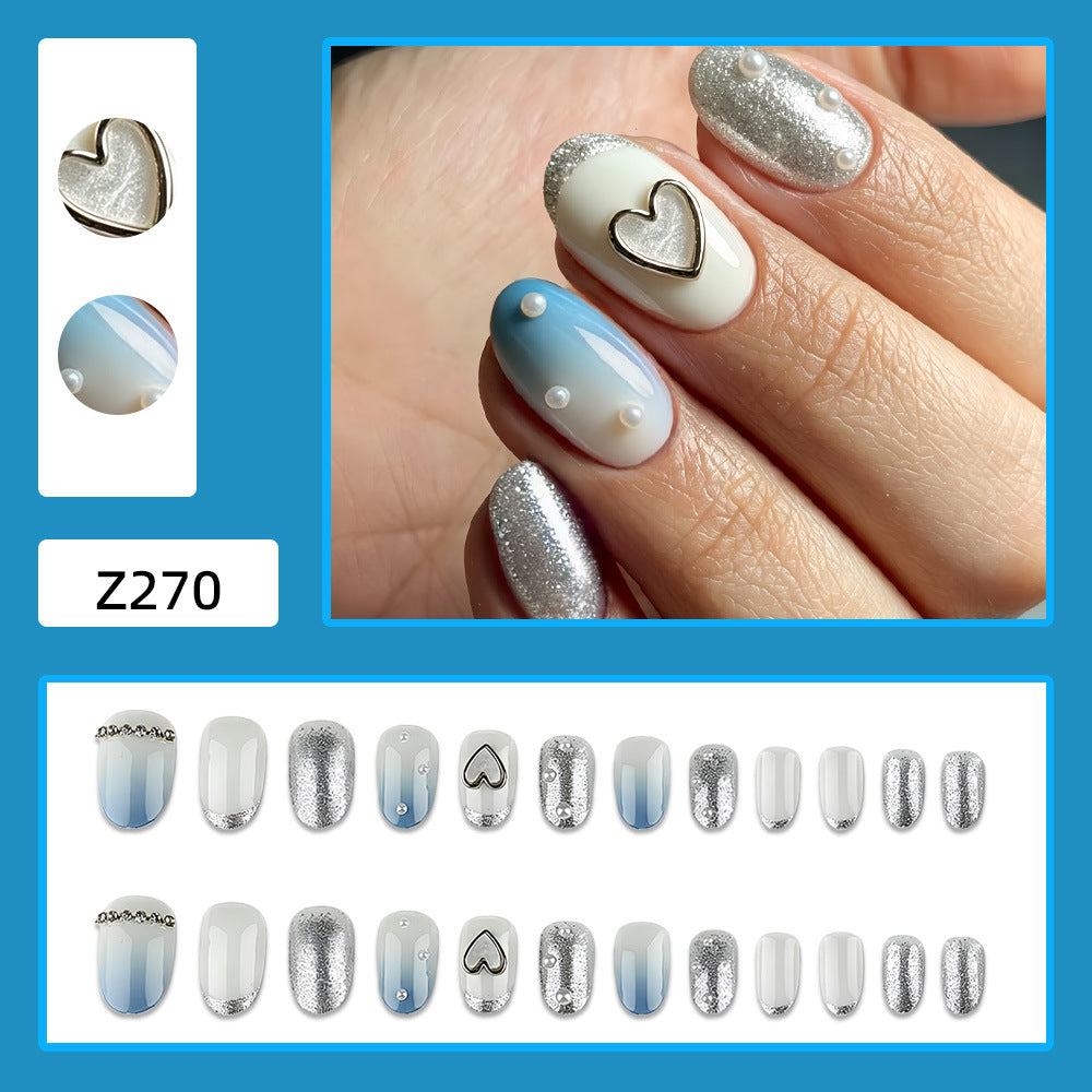 Glamorous artificial nails with heart design and pearl details Bowlift