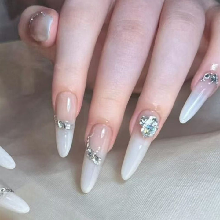 Acrylic nail set with elegant tips and glamorous rhinestone accents Bowlift