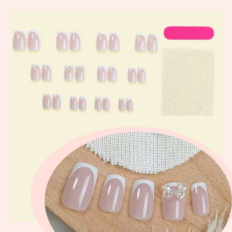 Artificial nail set with glamorous French tips and sparkling accents Bowlift