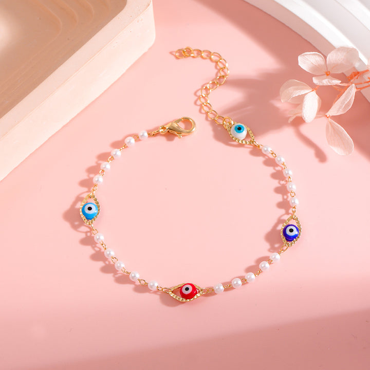 Elegant Pearl and Eye Charm Necklace Bowlift