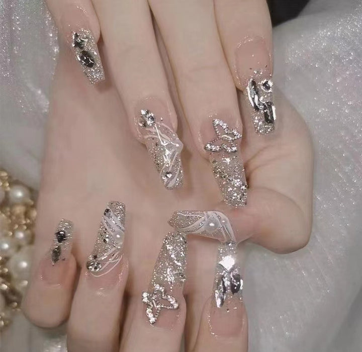 Artistic Nail Art with Glitter and Flower Applications Bowlift