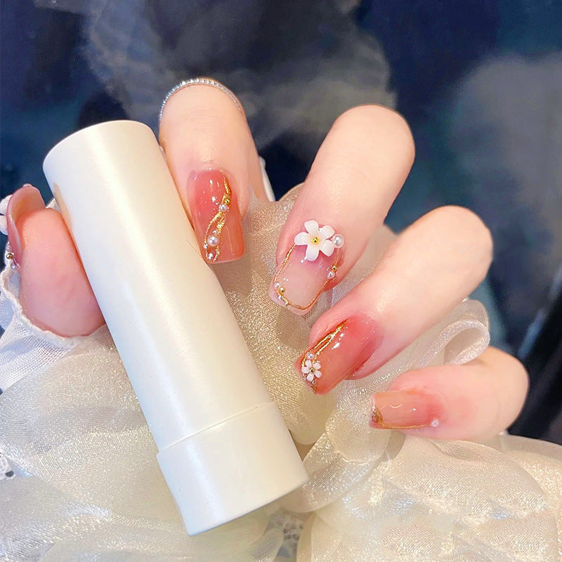 Acrylic nail set with elegant floral decorations and glamorous pearl accents Bowlift