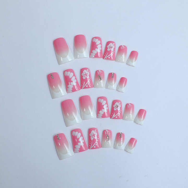 Acrylic nail set with elegant floral designs and glitter accents Bowlift