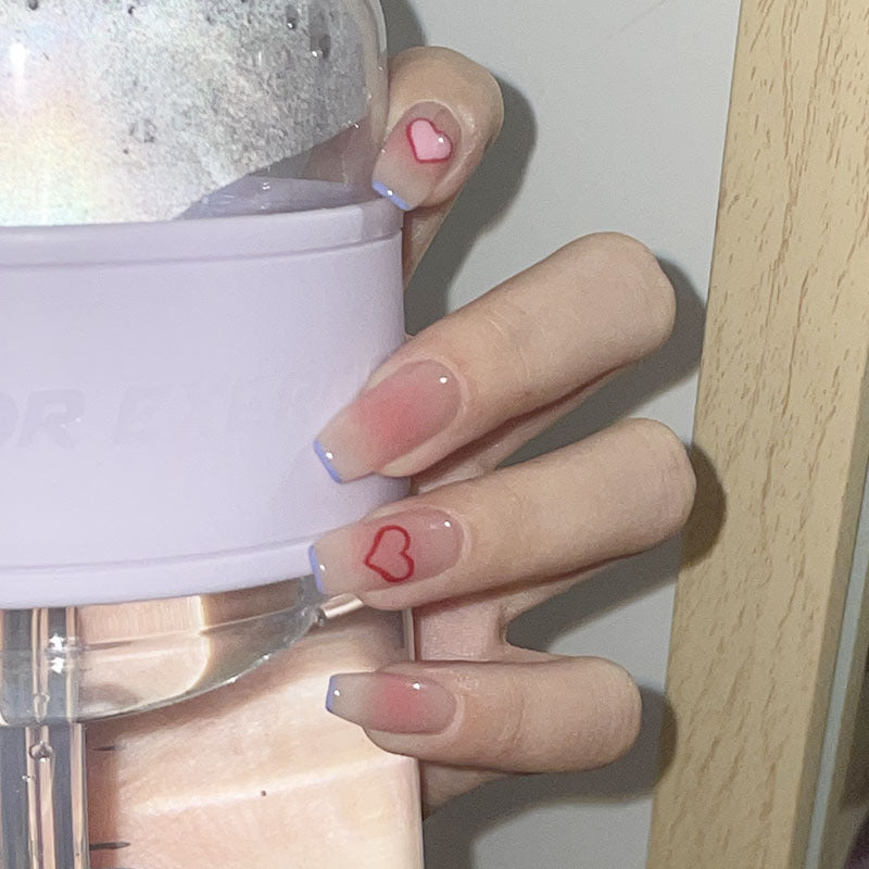 Glamorous artificial nails with heart design and glittering accents Bowlift
