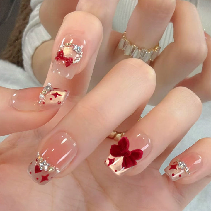 Artificial nail set with festive gift design and elegant glitter accents Bowlift