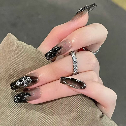 Glamorous artificial nails with heart design and glittering accents Bowlift