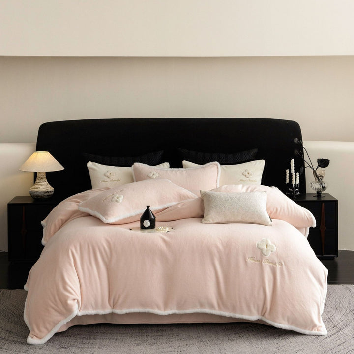 Cozy microfiber bedding set with plush surface, decorative flower appliqué and teddy trim