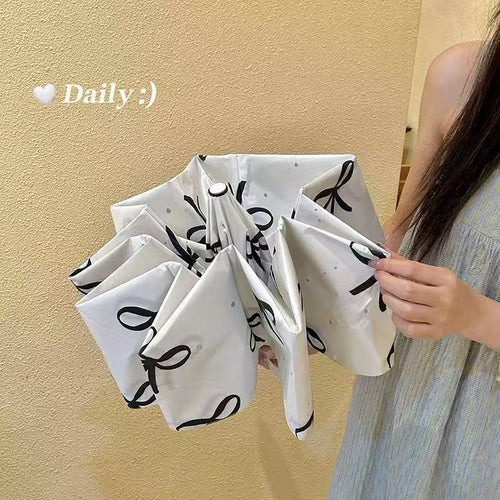 Women's foldable umbrella with elegant bow design Bowlift