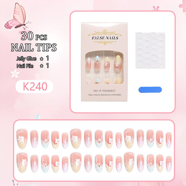 Artificial nail set with intricately detailed floral designs and shine accents Bowlift