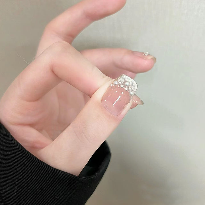 Elegant artificial nails with pearl decorations and glitter effects Bowlift