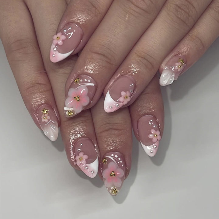 Artful nail extensions with floral patterns and glitter accents Bowlift