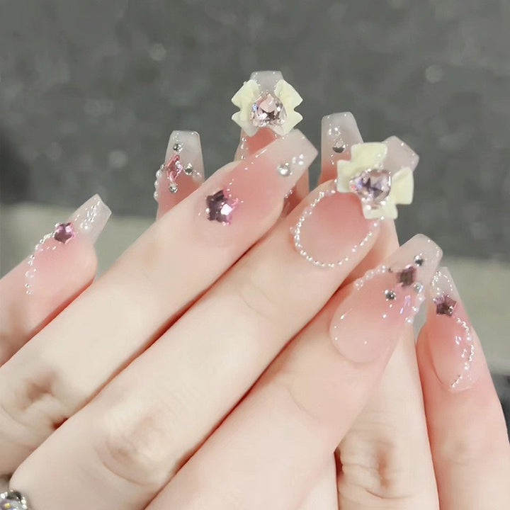 Artificial nails with glitter accents and playful motifs Bowlift