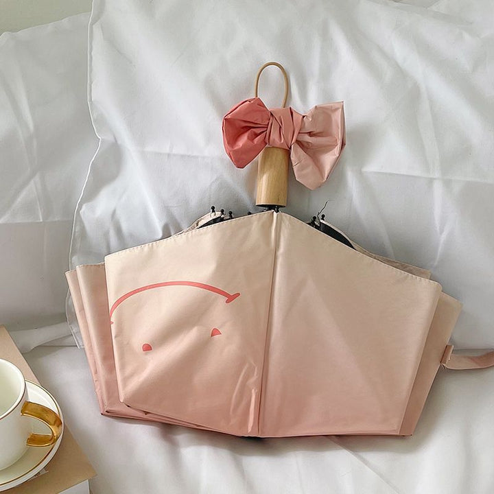 Women's foldable umbrella with playful design and handy wooden handle Bowlift