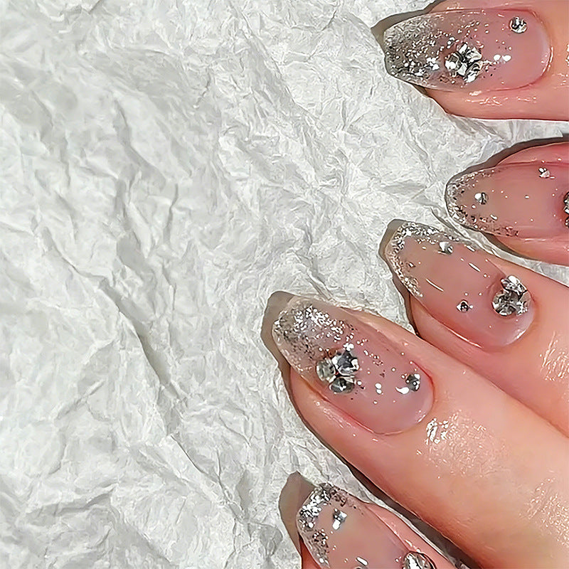 Glamorous artificial nails with glitter and rhinestone embellishments Bowlift