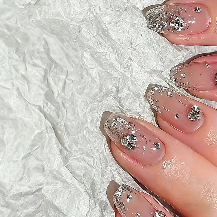 Glamorous artificial nails with glitter and rhinestone embellishments Bowlift