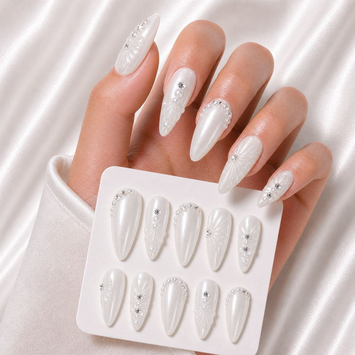 Elegant Stiletto Nail Enhancements with Decorative Pearls Bowlift