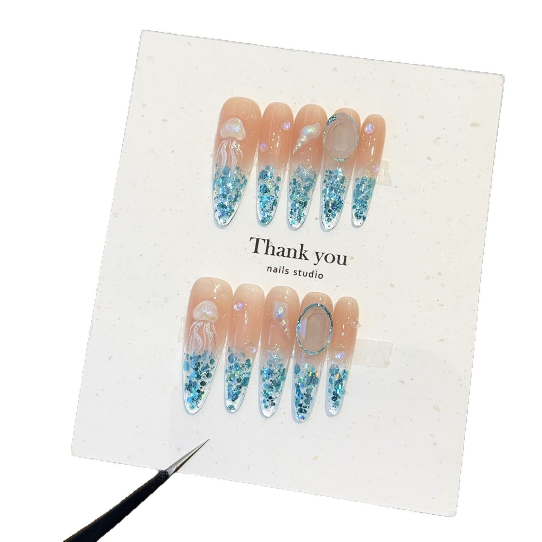 Creative artificial nails with maritime designs and sparkling accents Bowlift