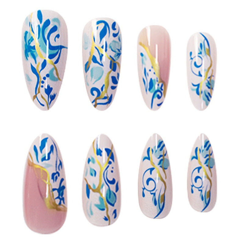 Artistic Floral Press-On Nail Design with Gold Accents Bowlift