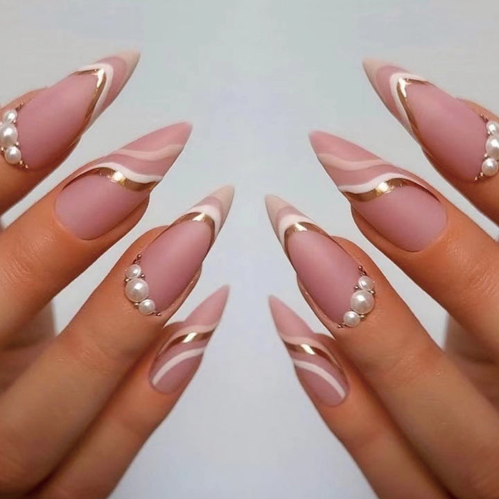 Artful stiletto nails with elegant gold and white accents Bowlift