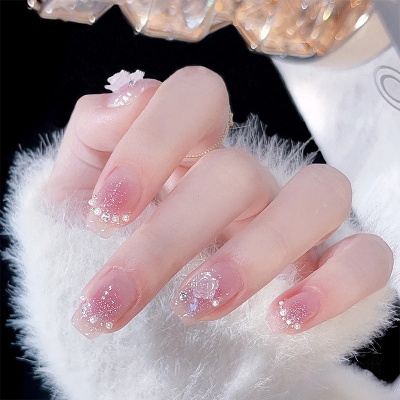 Artificial nail set with sparkling glitter and pearl decorations Bowlift