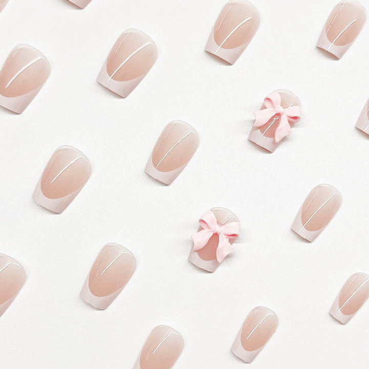Decorative French Tip Nail Extensions with Bow Accents Bowlift