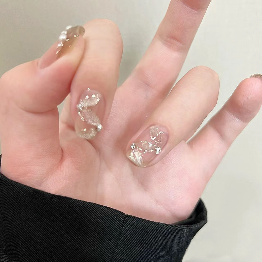 Elegant artificial nails with pearl decorations and glitter effects Bowlift