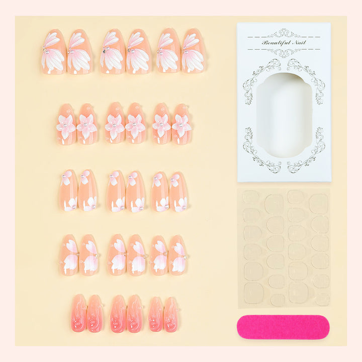 Artificial nail set with floral motifs and rhinestone decorations Bowlift