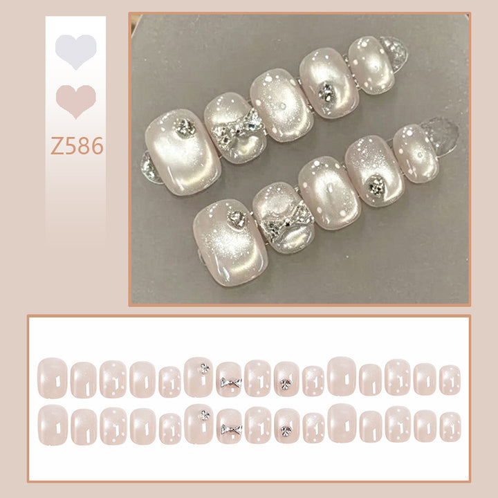 Artificial nail set with elegant glitter and crystal decorations Bowlift