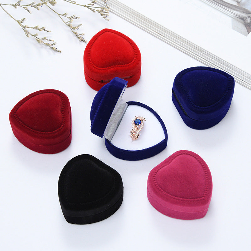Heart-shaped velvet ring box with cushioned white interior and secure ring slot Bowlift