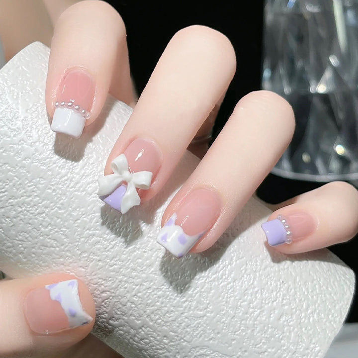 Nail art set with elegant wave patterns and delicate pearl accents Bowlift