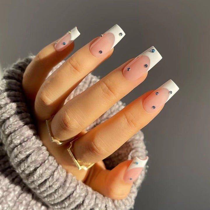 Artistic artificial nails in elegant French tip design with glitter accents Bowlift