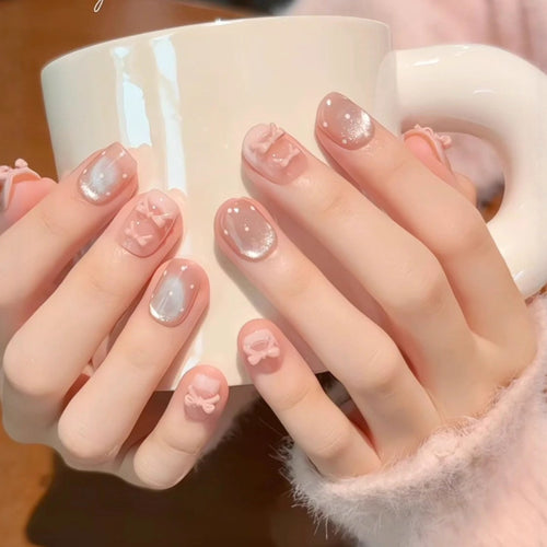 Artificial nails with delicate bows and glitter accents Bowlift