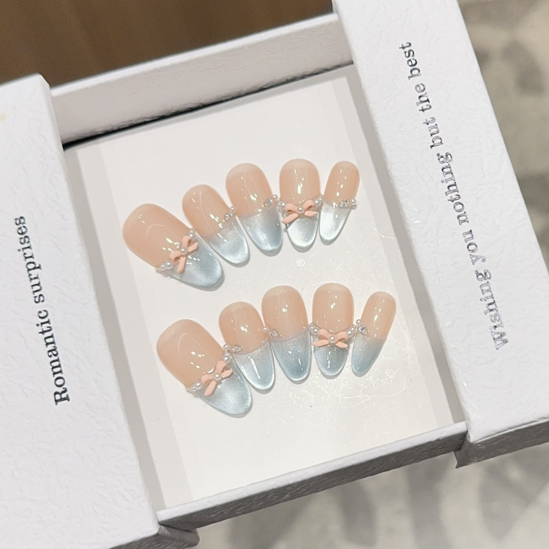 Artificial nail set with romantic bow and glitter accents Bowlift