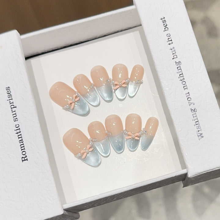 Artificial nail set with romantic bow and glitter accents Bowlift