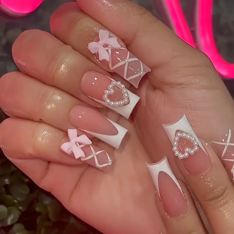 Elegant artificial nail tips with heart and bow accents Bowlift