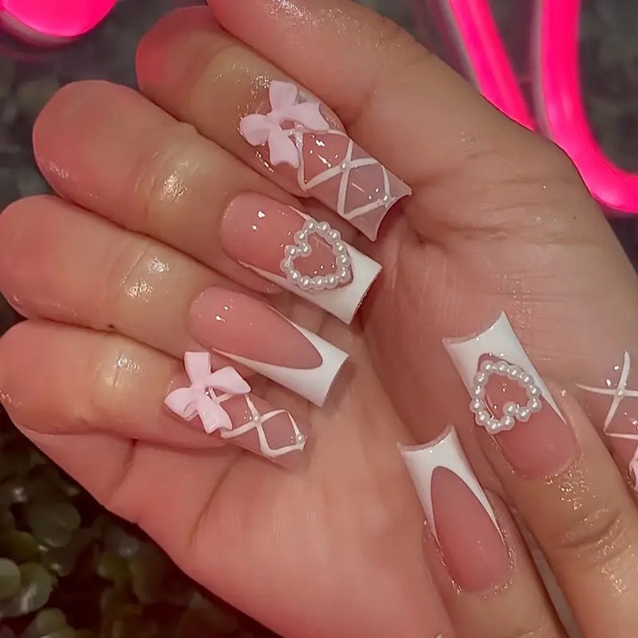 Elegant artificial nail tips with heart and bow accents Bowlift