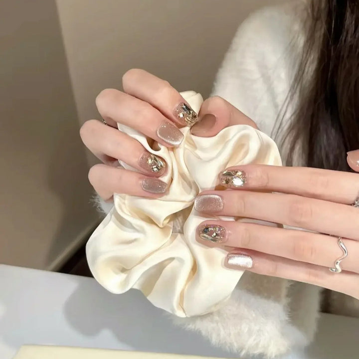 Elegant artificial nails with sparkling gold accents Bowlift