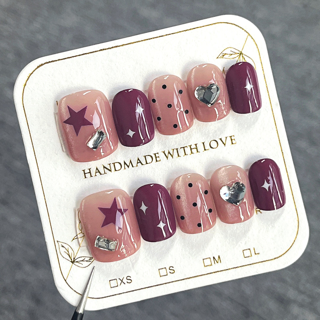 Artificial nail extensions with unique jewelry accents Bowlift