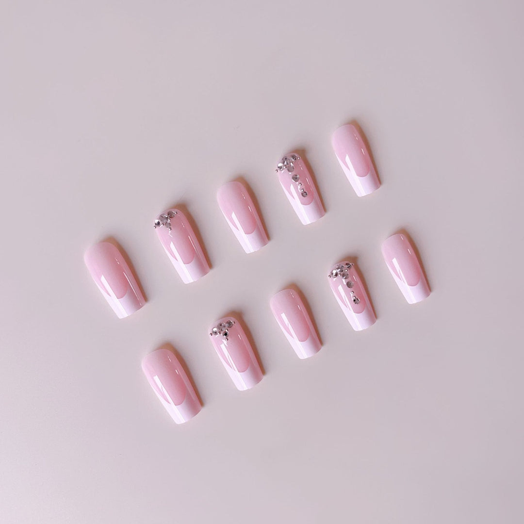 Acrylic nail set with elegant French tips and sparkling rhinestone accents Bowlift