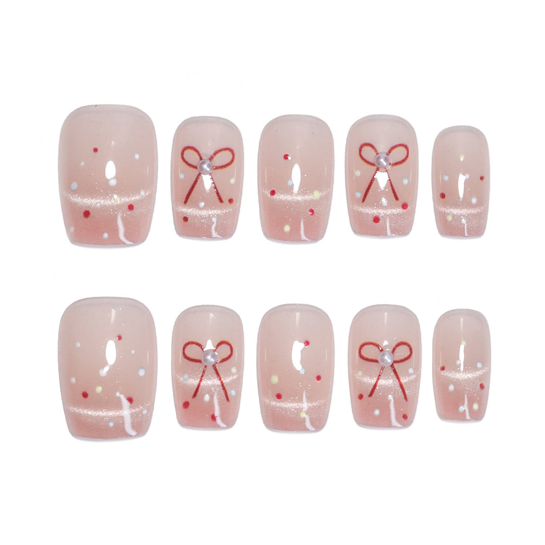 Artificial nail art with elegant bows and glitter accents Bowlift