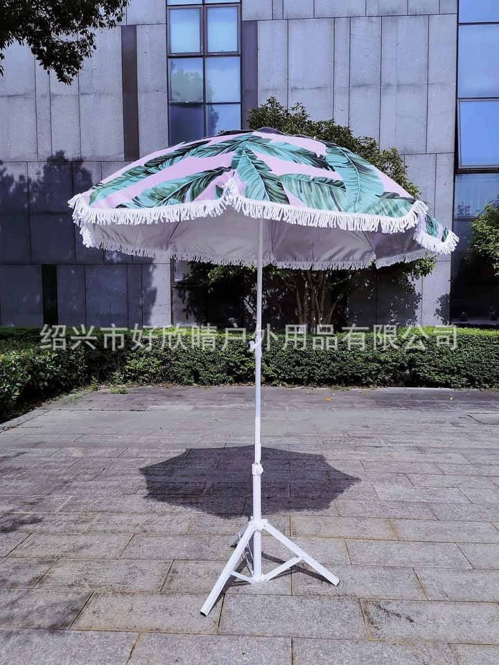 Ladies sun umbrella with tropical leaf design and tassel decoration Bowlift