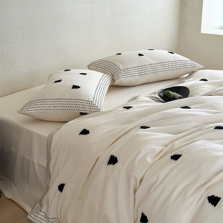 Modern bedding set made of cotton percale with subtle triangle embroidery appliqués